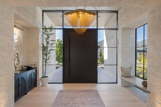 Entry with stone walls and pivot door